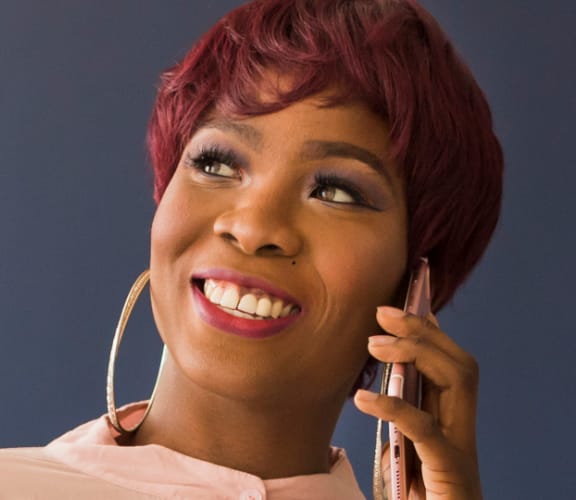 Woman standing in an office and talking on a cell phone